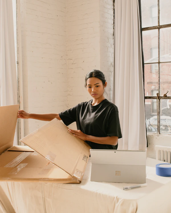 Online store owner packing an order